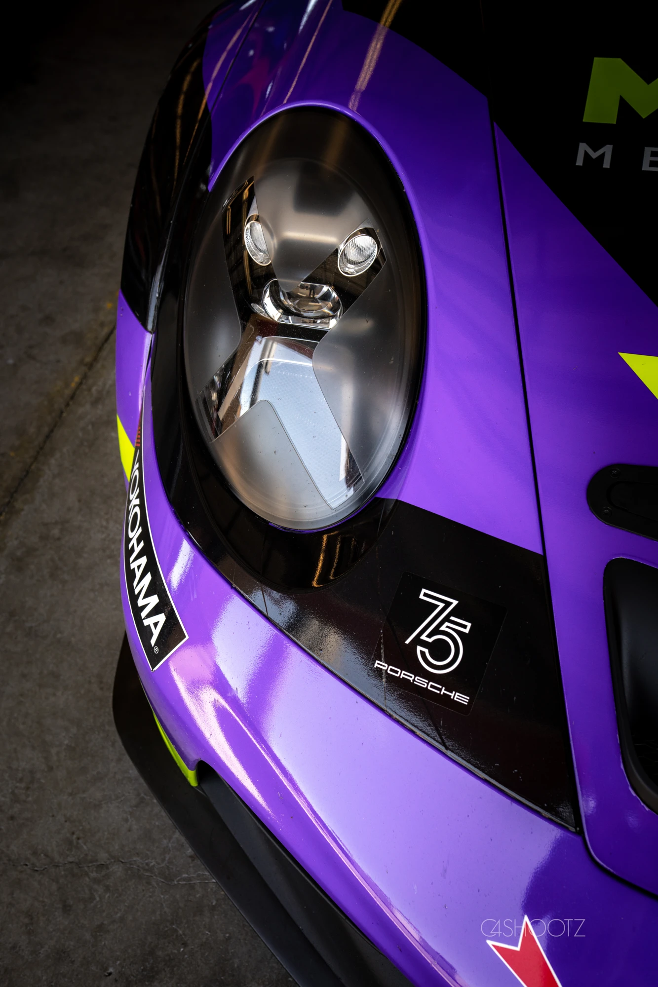 Headlight detail on the purple and lime Porsche race car
