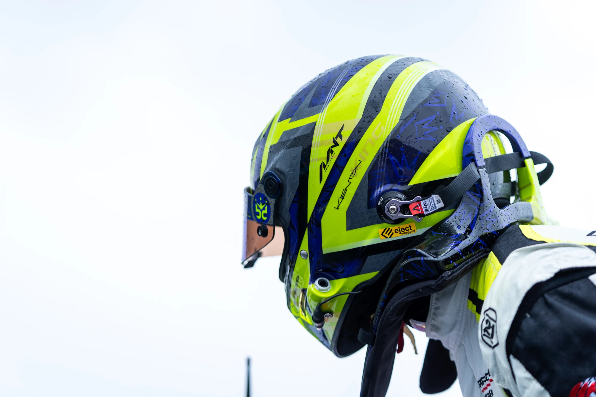 Close-up of Kenton’s purple and lime helmet with the Avant logo and crown design