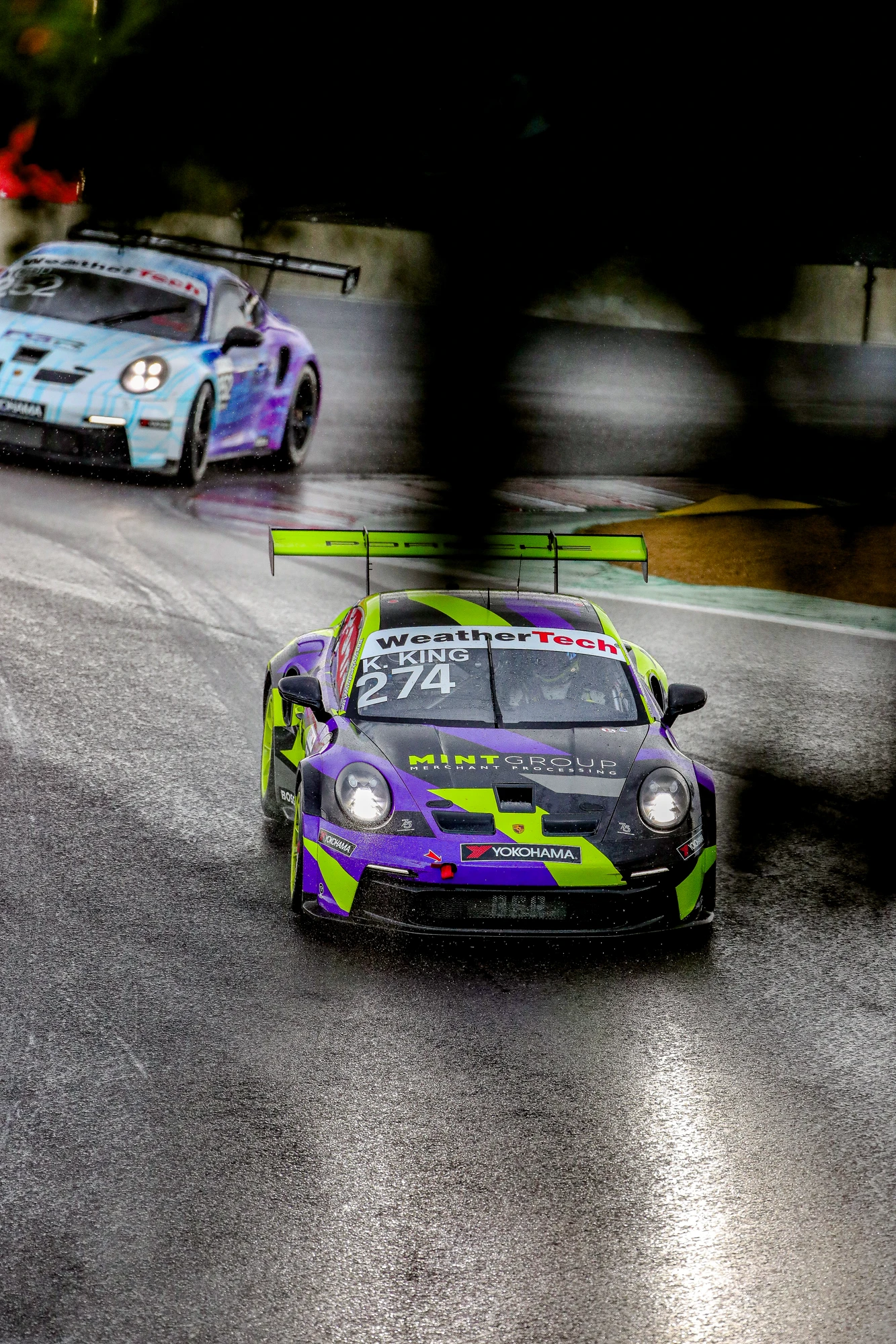 Number 274 Porsche racing on a wet circuit